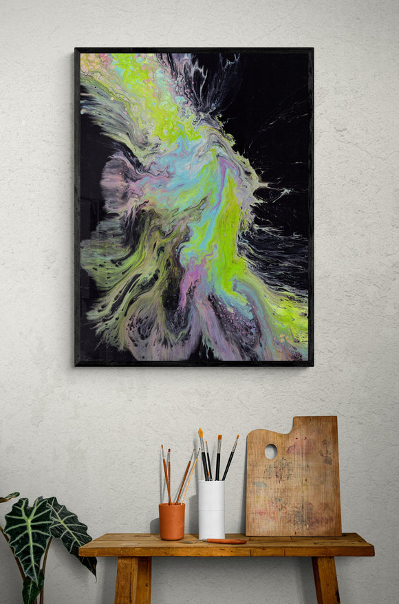 An Explosion of Colour by James Knights hung on a wall above a small wooden desk. The painting is an organic abstract with a black background with bright green and blue running across is